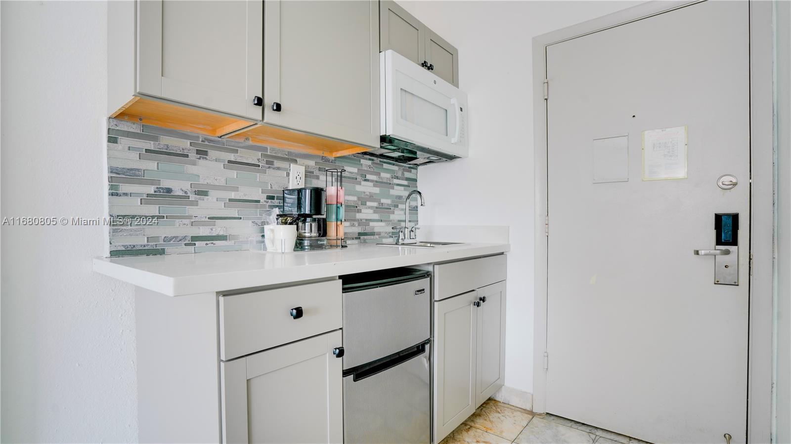 a kitchen with cabinets and appliances