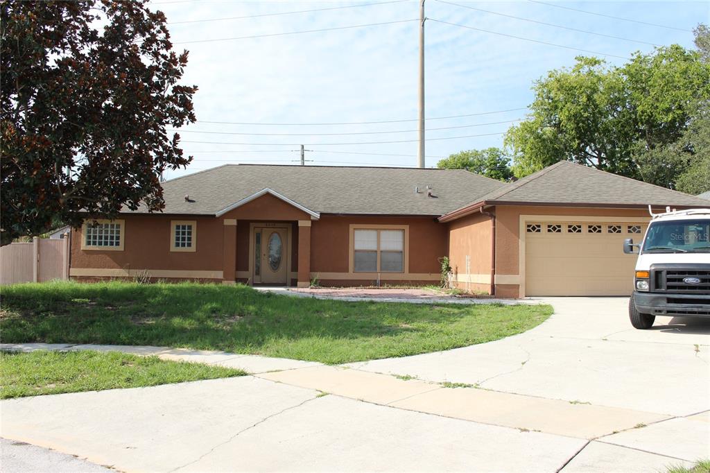 a front view of a house with a garden and yard