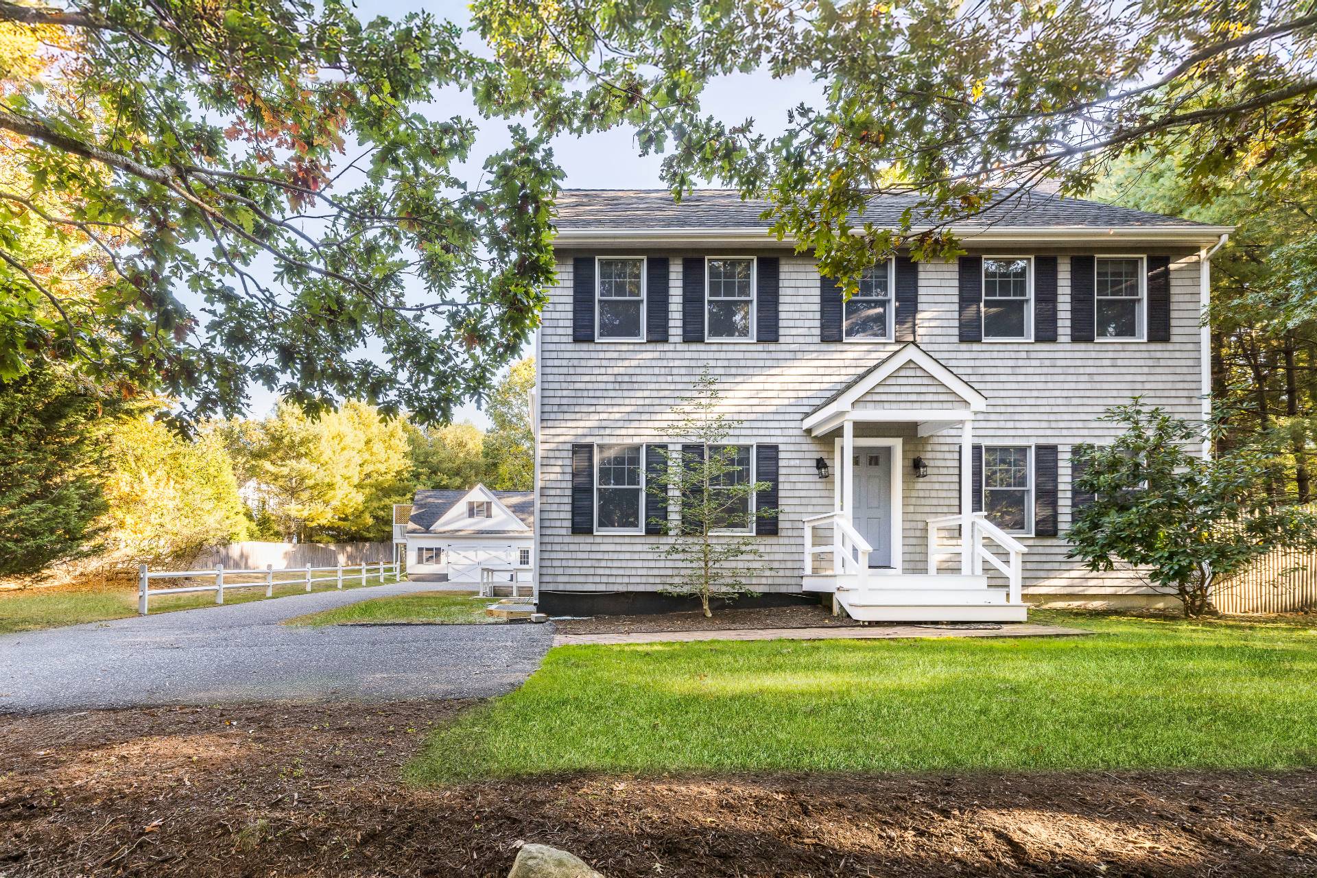 a front view of house with yard and green space