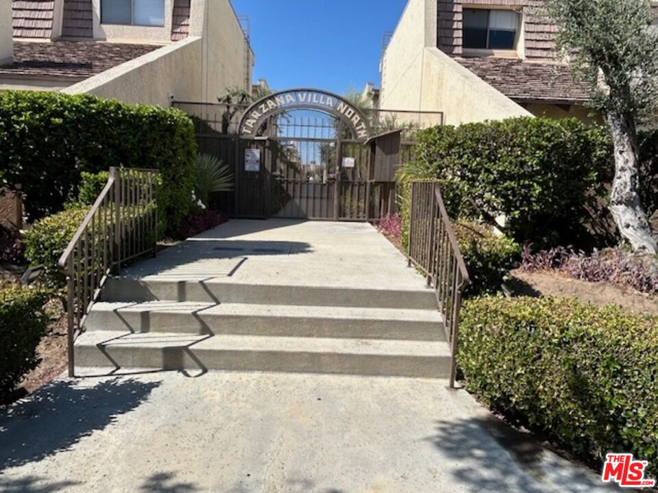 a pathway of a house with a yard