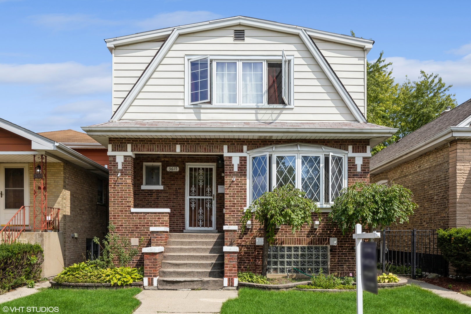 a front view of a house with garden