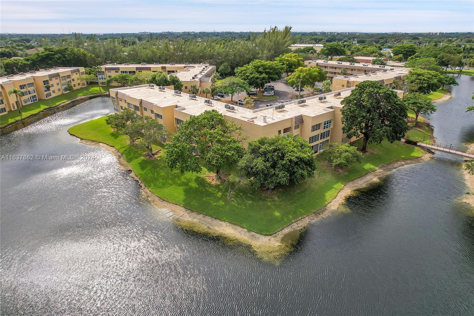 an aerial view of a house with a garden and lake view