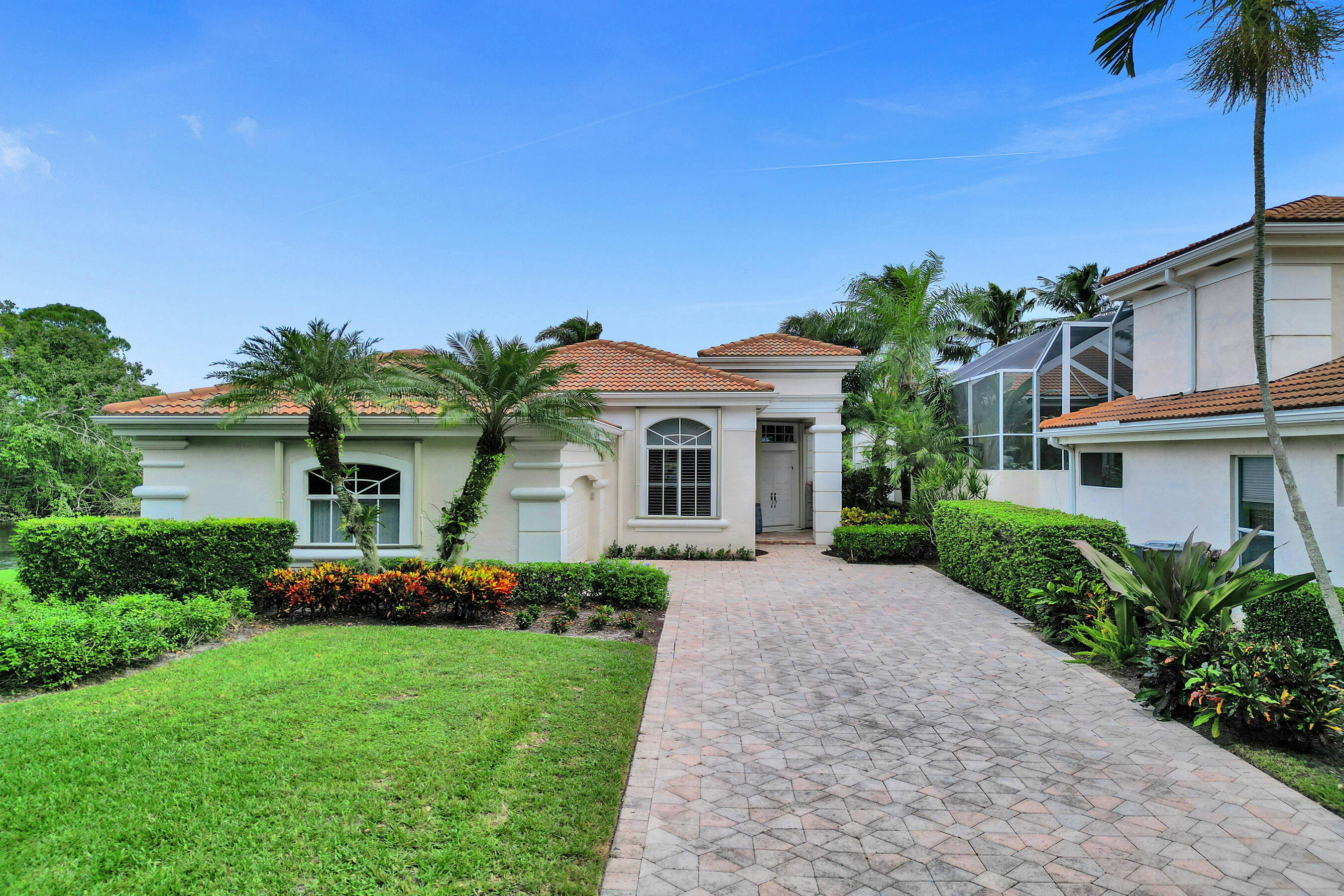 a front view of a house with a garden