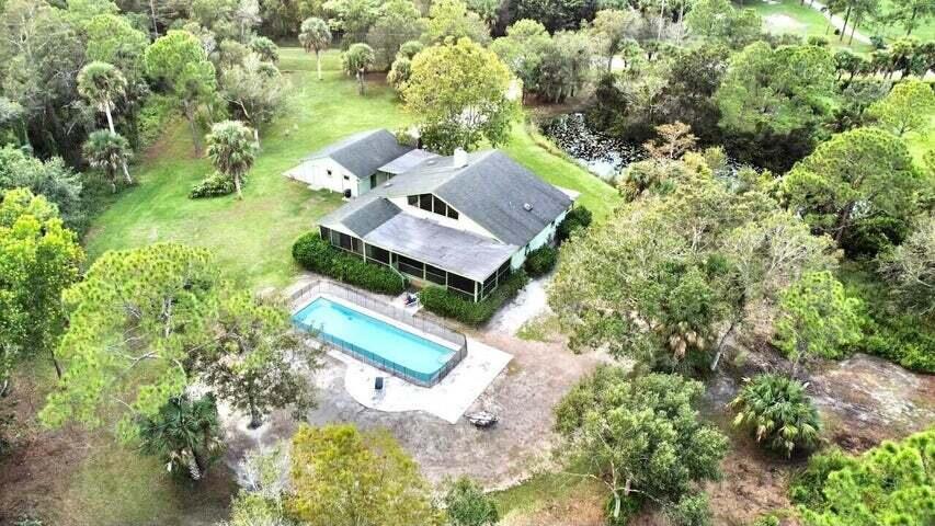 an aerial view of a house with a yard