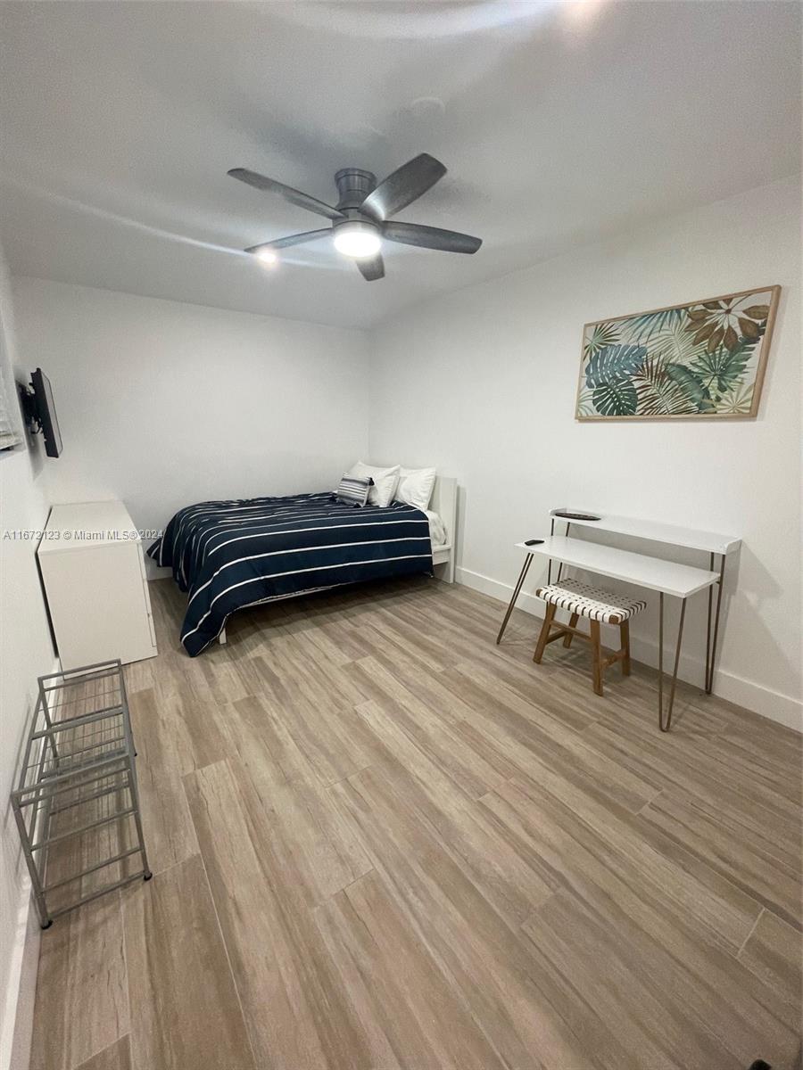 a bedroom with furniture and a wooden floor