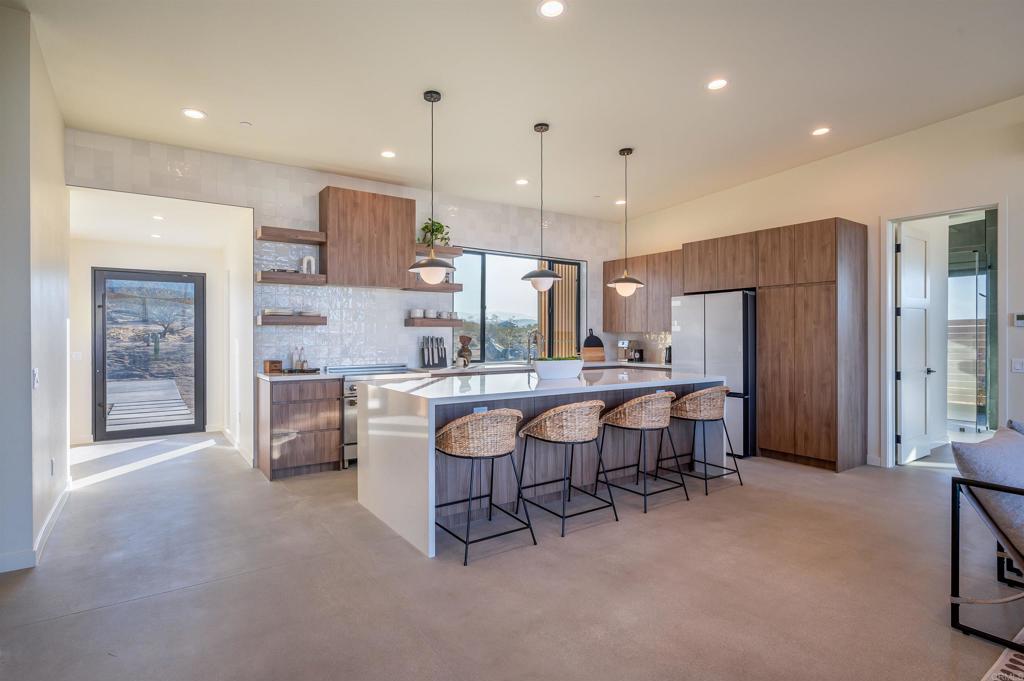 a large kitchen with a table and chairs