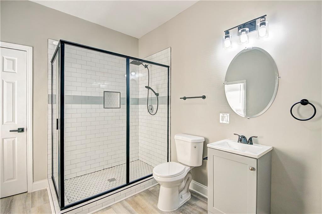 a bathroom with a toilet a sink and a mirror