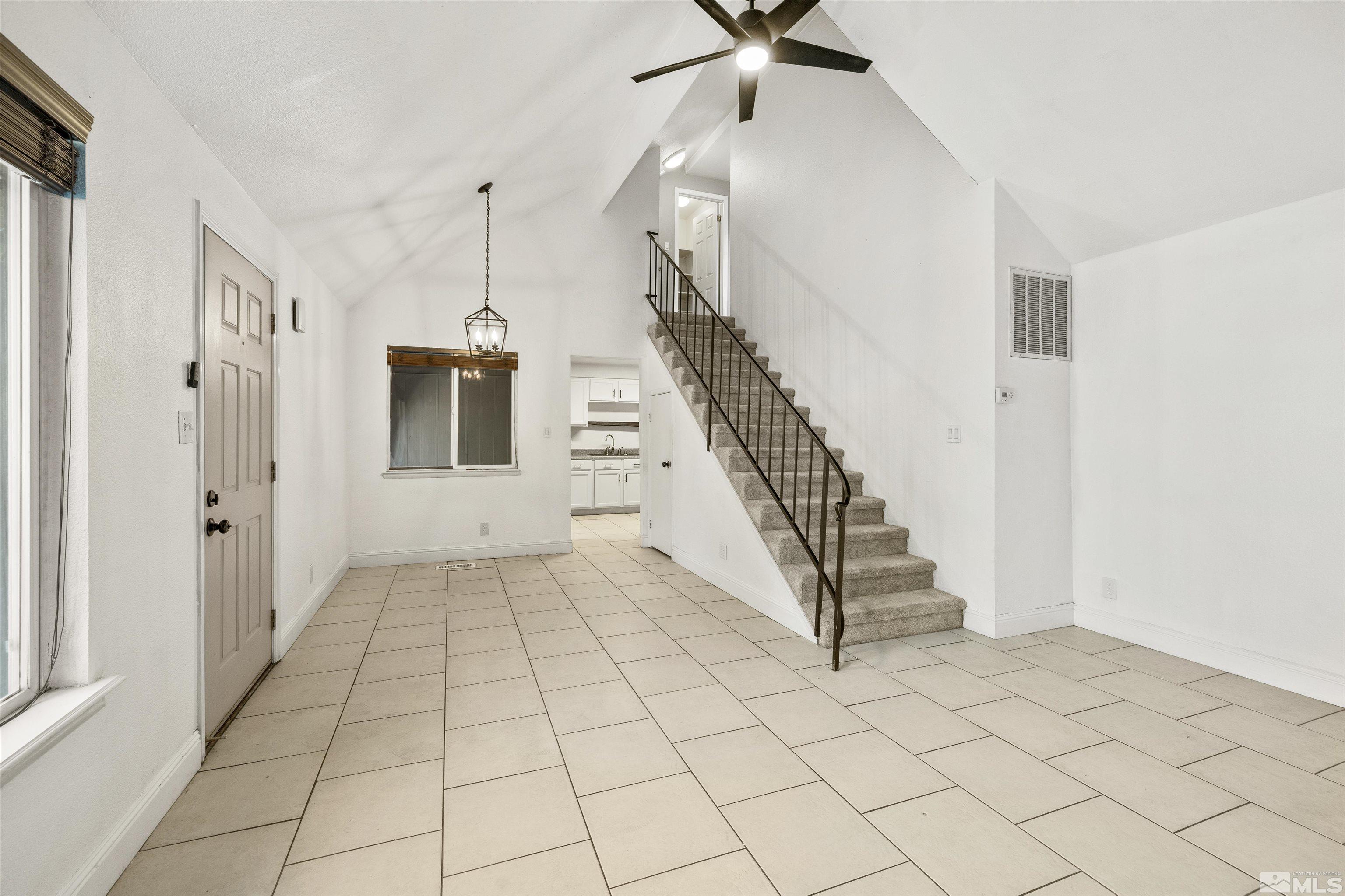 a view of a livingroom with wooden floor and white walls