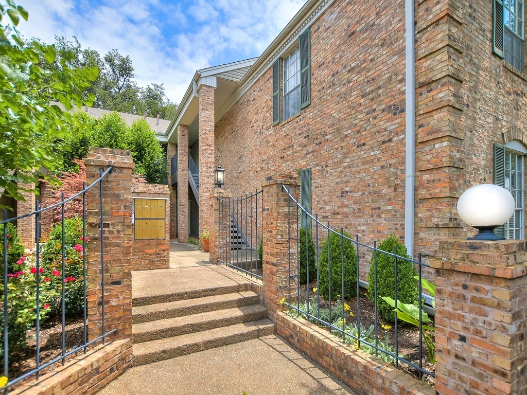 a view of a building with a yard and garden