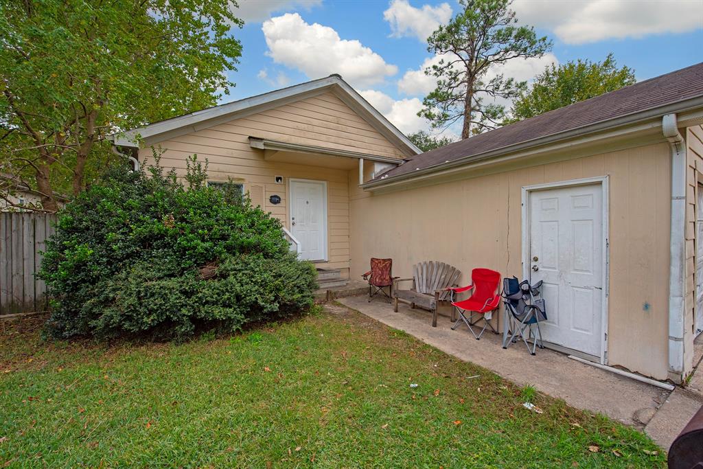 a backyard of a house with table and chairs