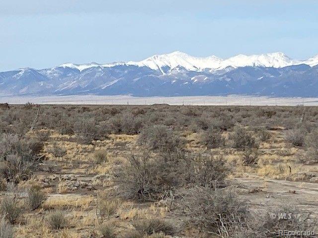 a view of a field with mountains in the background