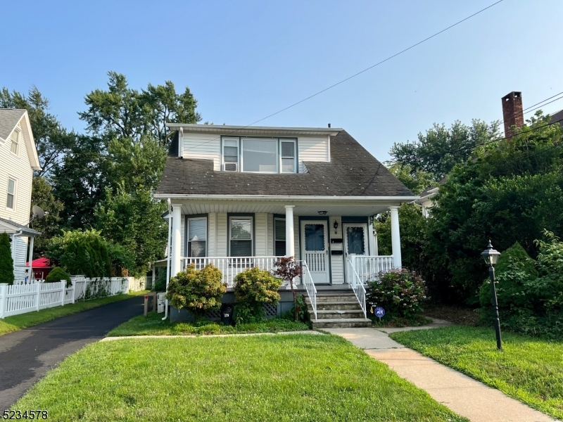 a front view of a house with a yard and porch