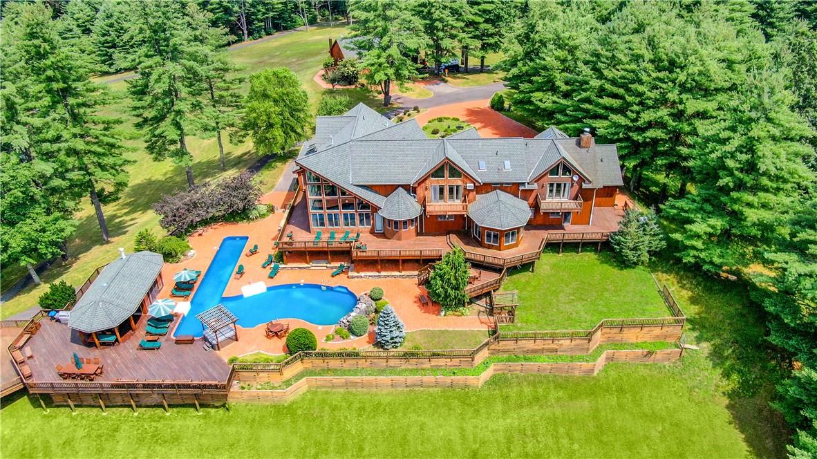 an aerial view of residential houses with outdoor space and swimming pool