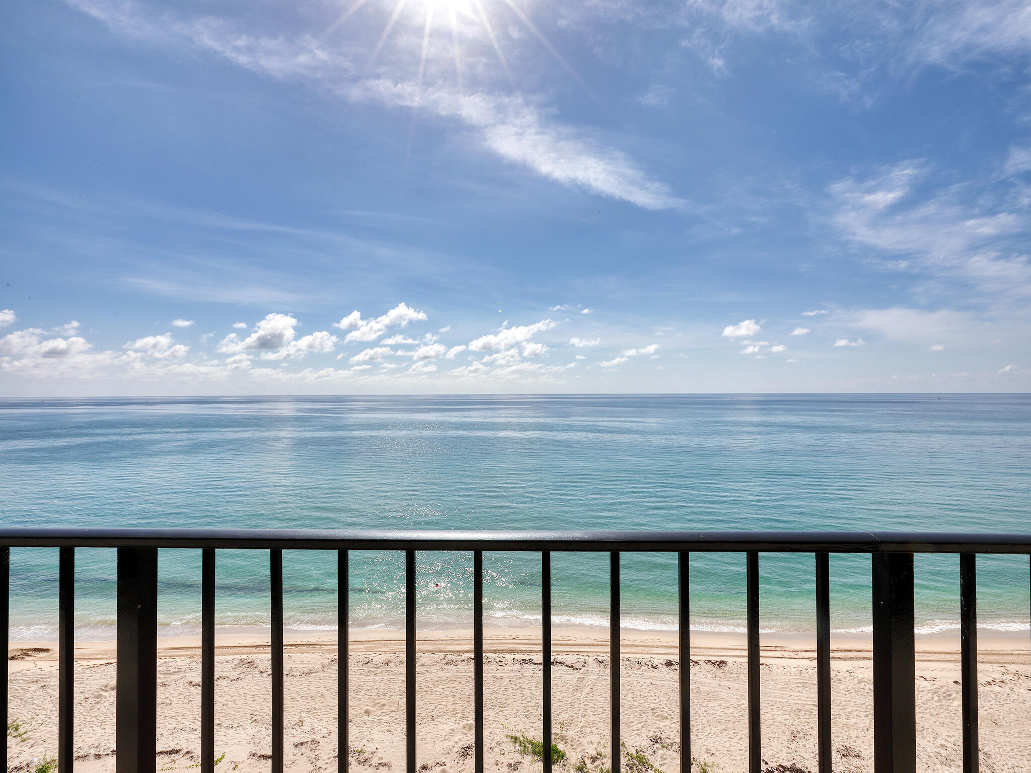 a view of a balcony next to a yard