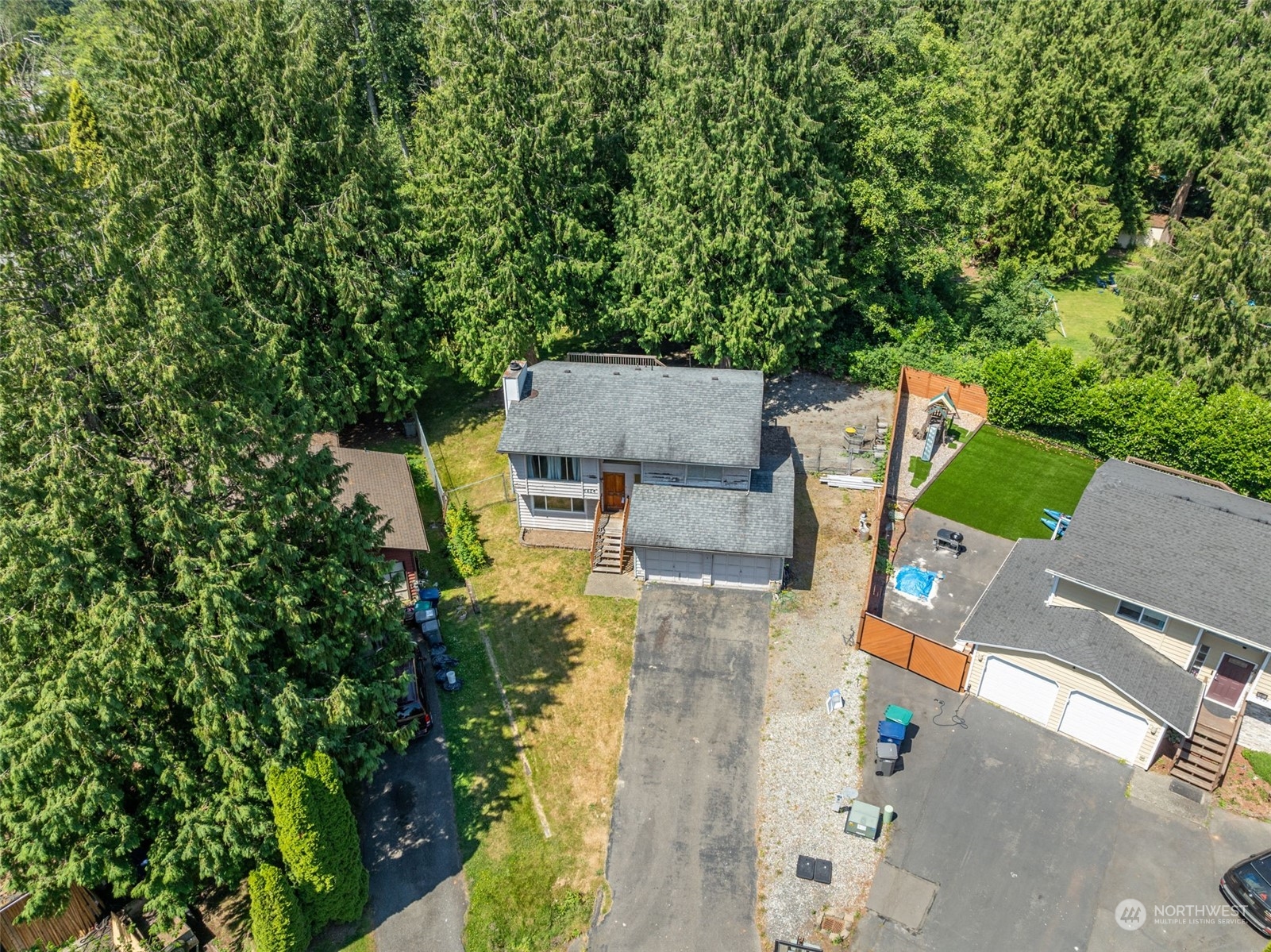 an aerial view of a house with swimming pool and garden