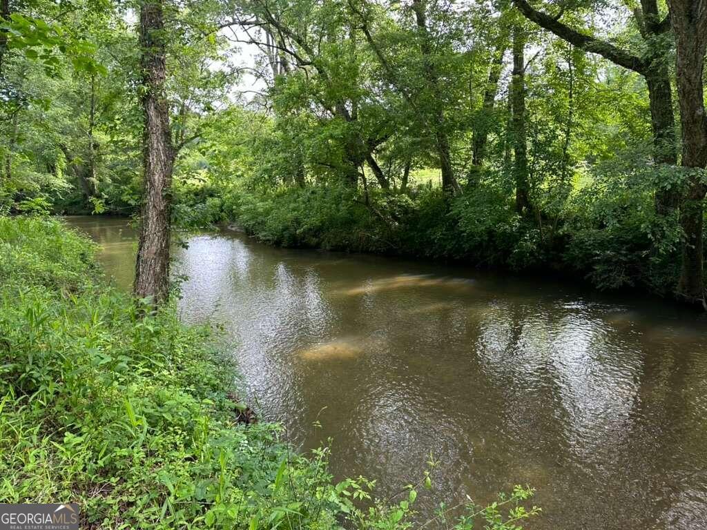 a view of a lake with green space