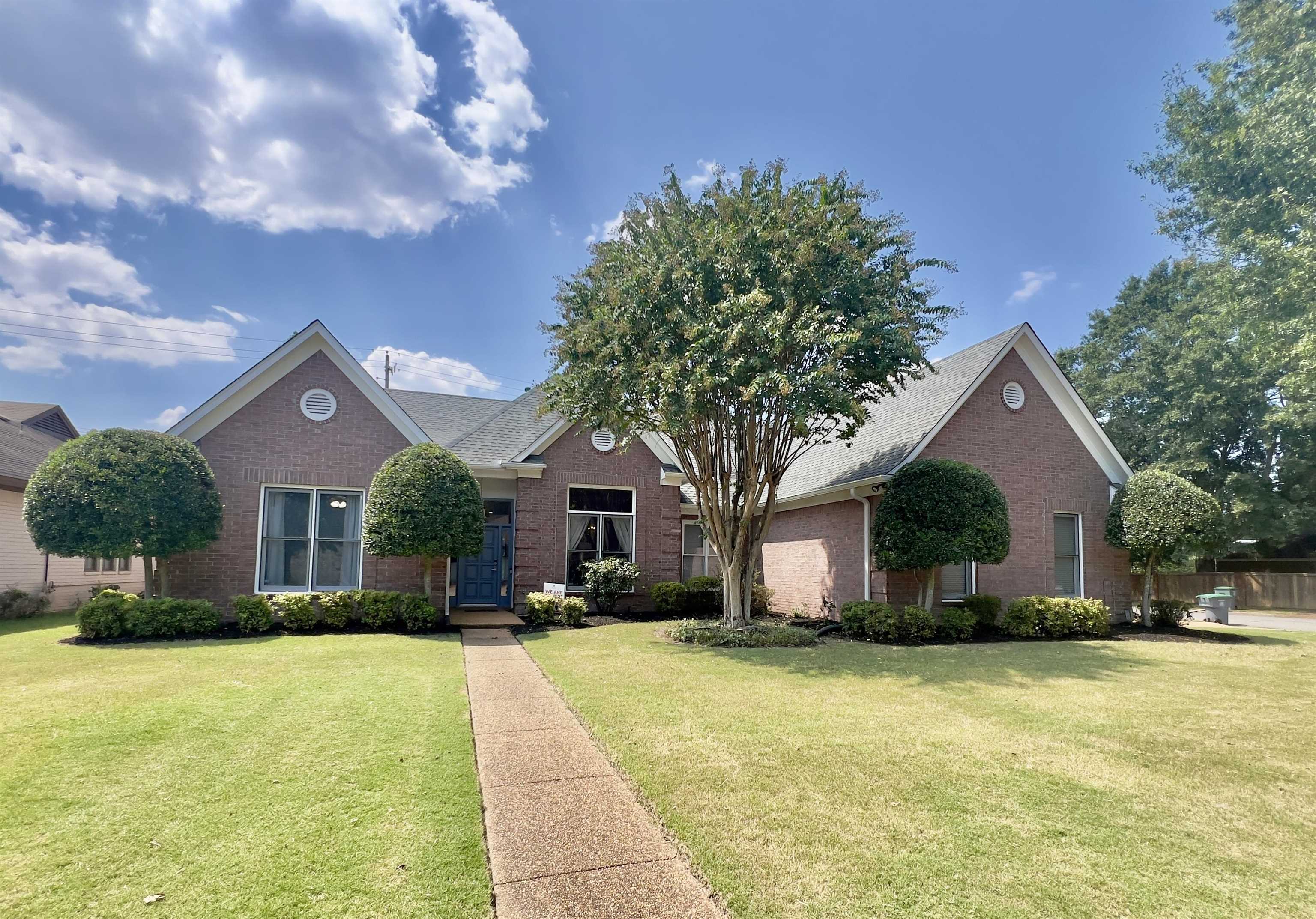 a front view of house with yard and trees