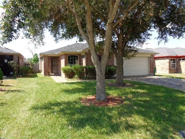 a view of a house with a yard and tree s