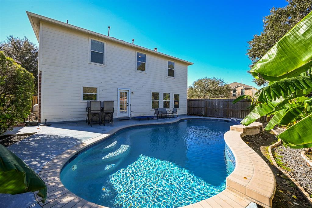 a view of a backyard with sitting area