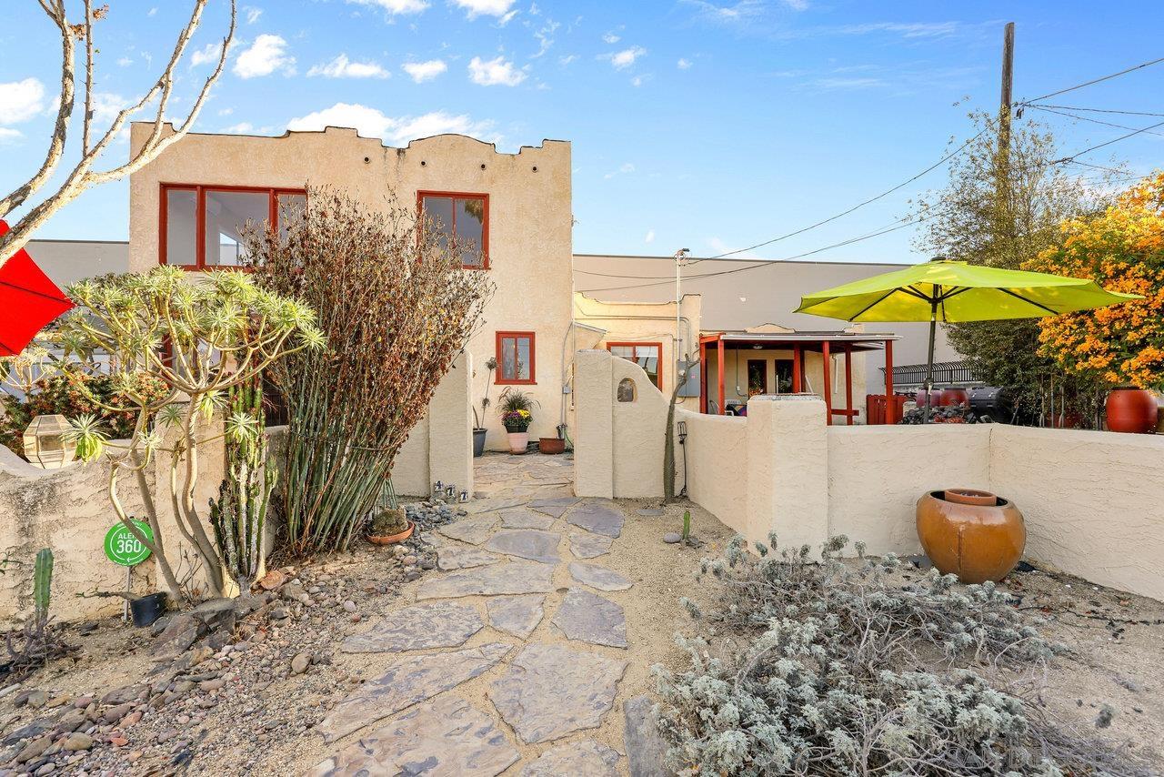 a view of a house with a backyard and sitting area