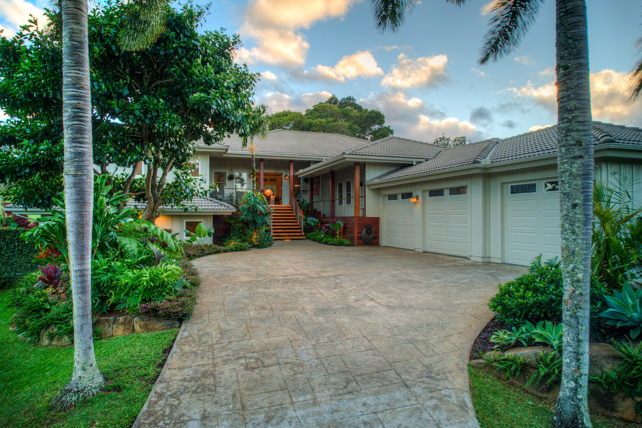 a view of a house with backyard and sitting area