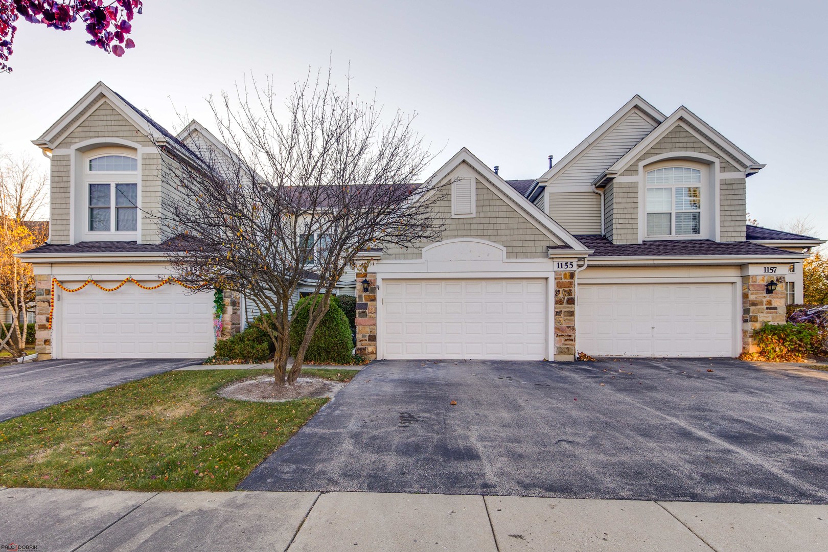 a front view of a house with a yard and garage