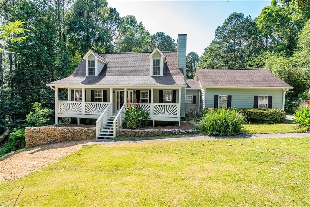 a front view of house with yard and swimming pool