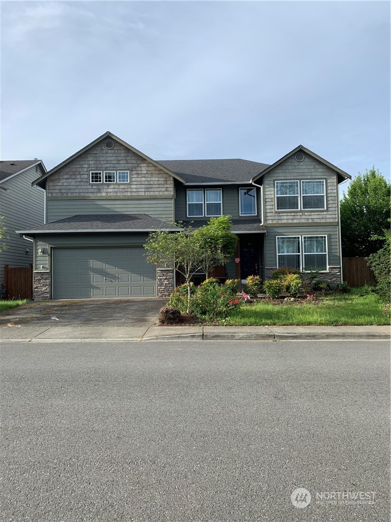 a front view of a house with a yard and garage