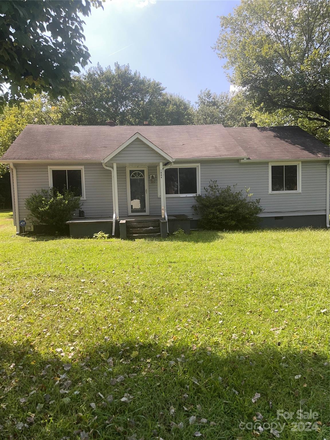 a front view of house with yard and trees