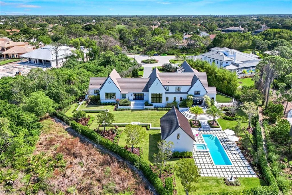 an aerial view of multiple houses with a big yard