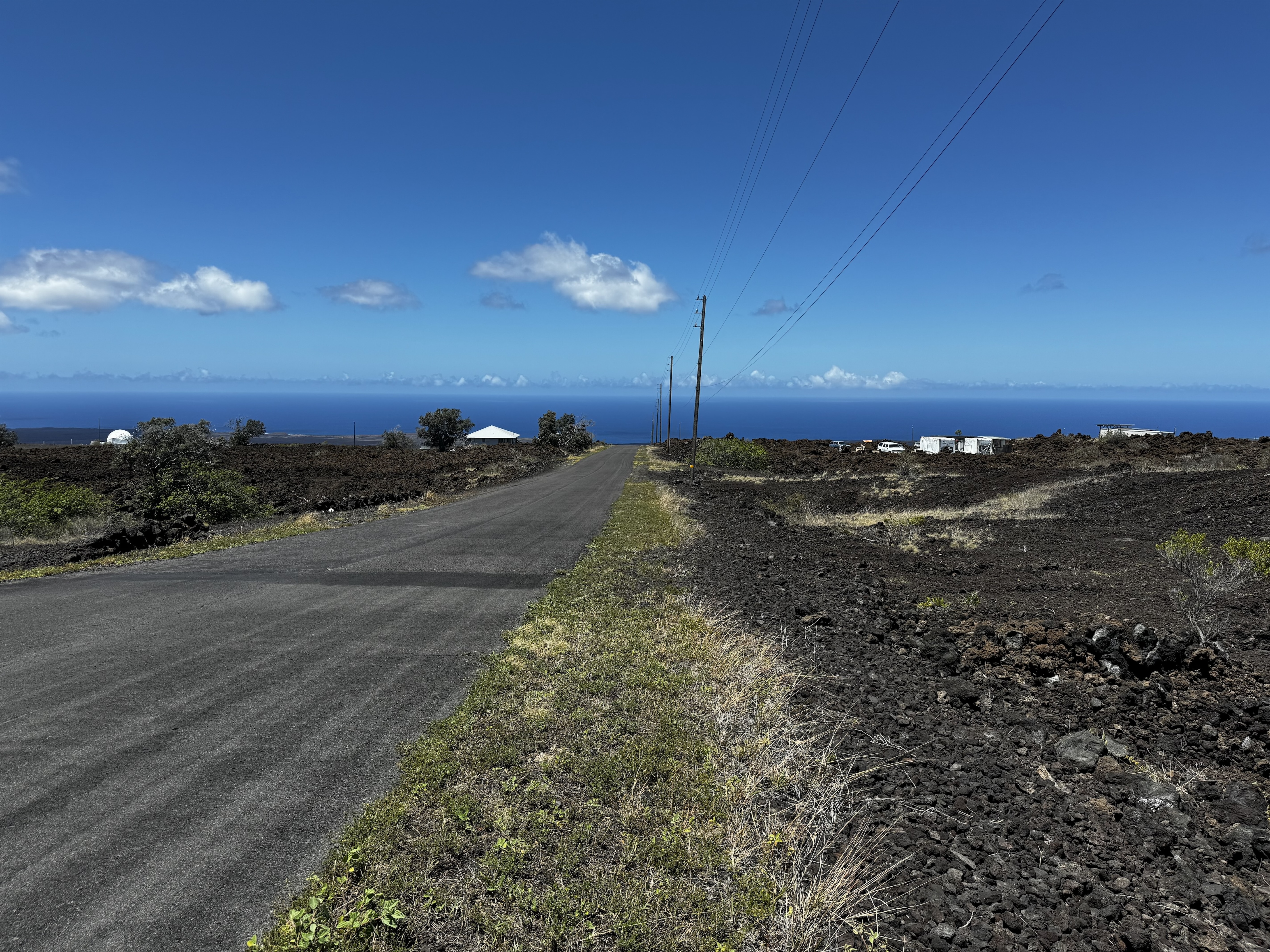 a view of a backyard of a house with a road