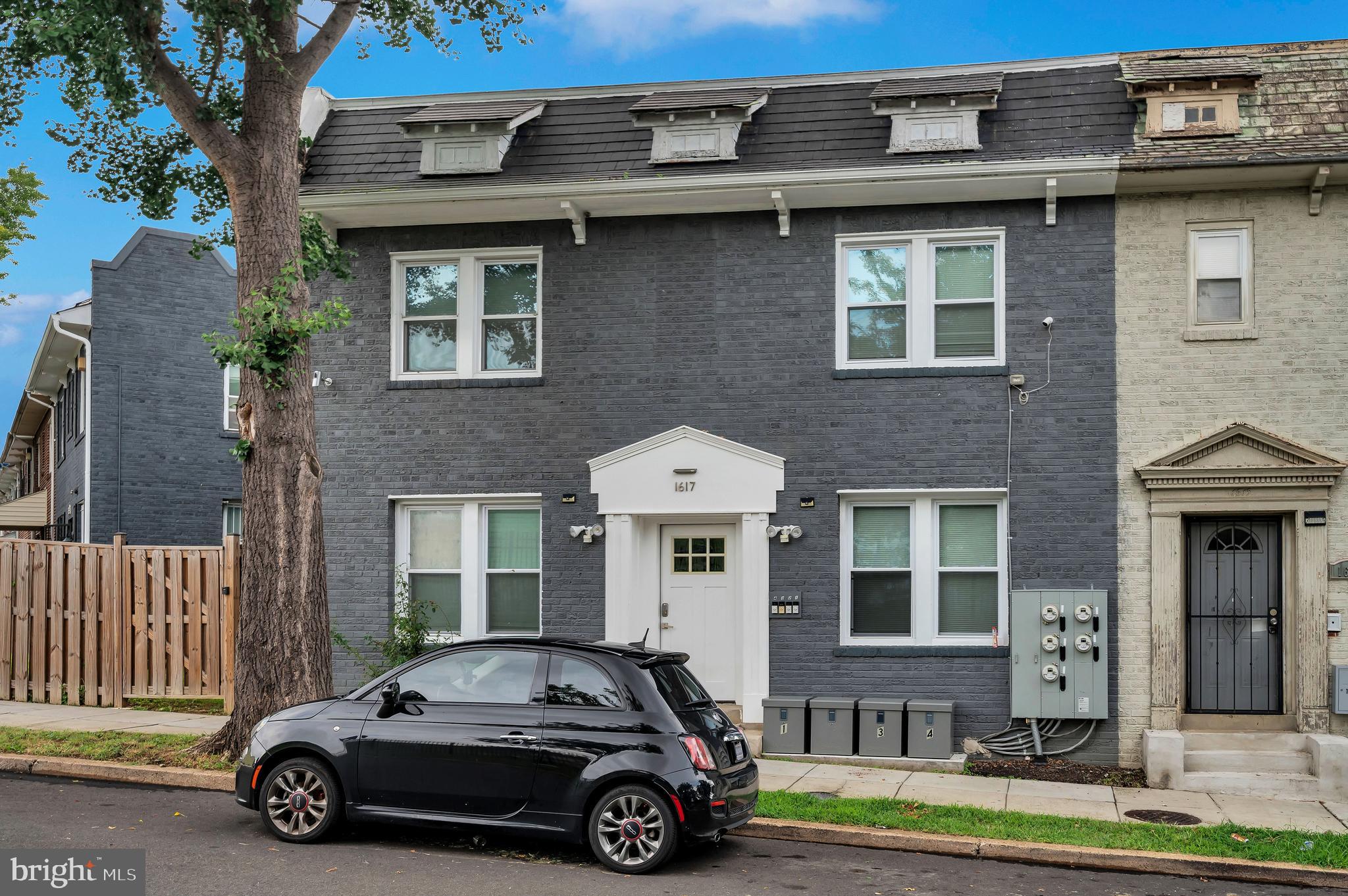 a car parked in front of a brick house