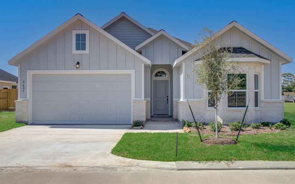 a front view of a house with a yard garage and outdoor seating