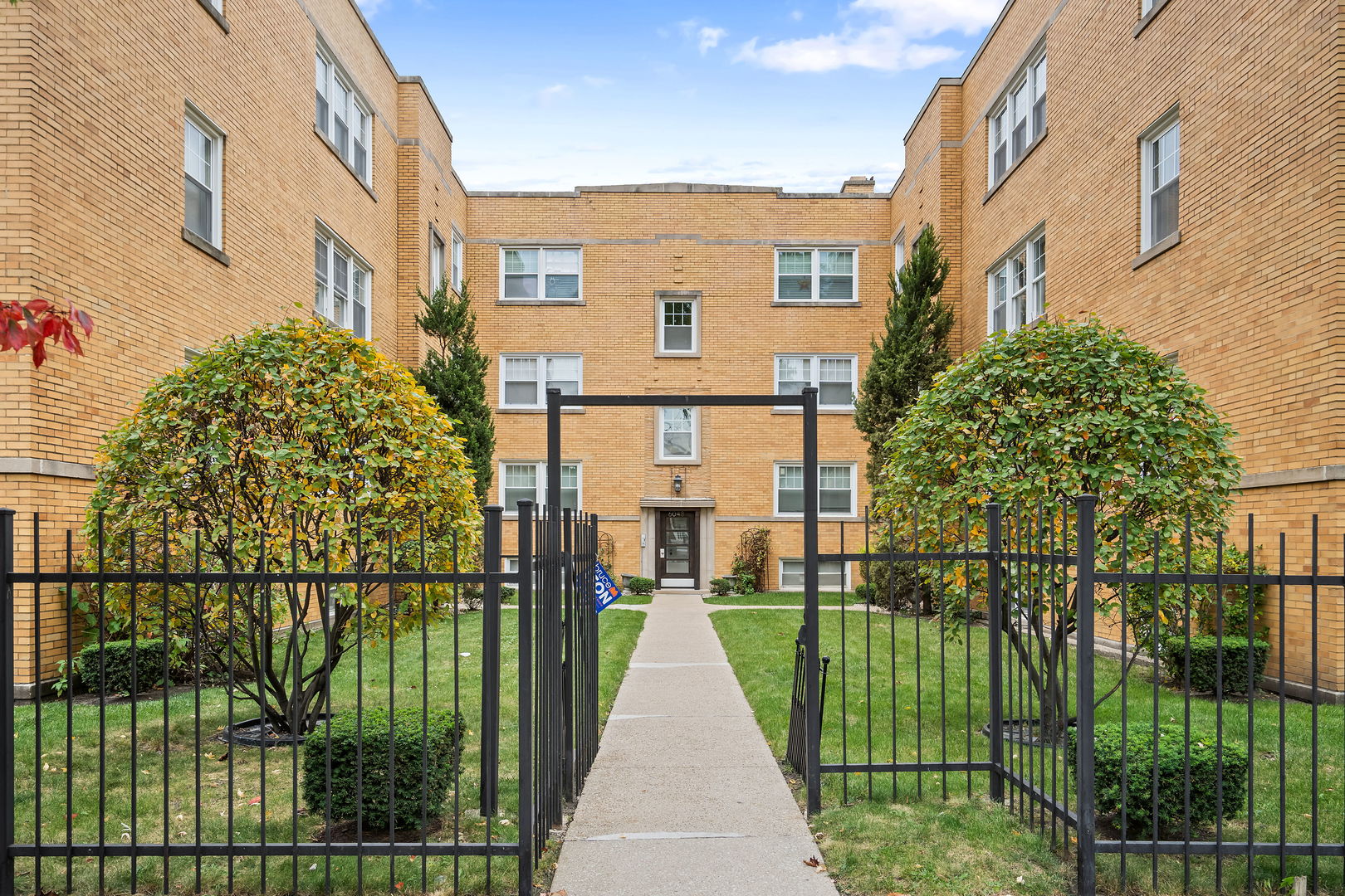 a view of a brick building with a yard