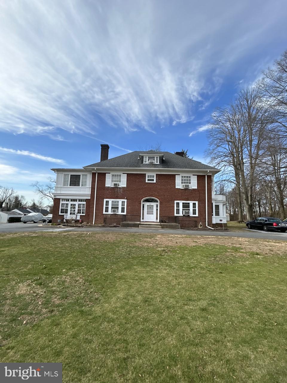 a front view of a house with a garden