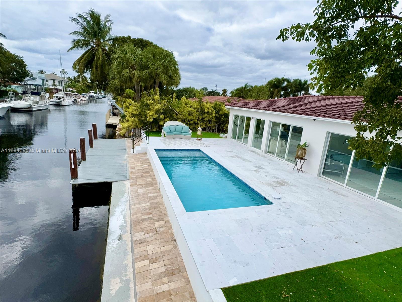 a view of a house with pool porch and sitting area