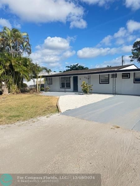 front view of house with a yard and ocean view