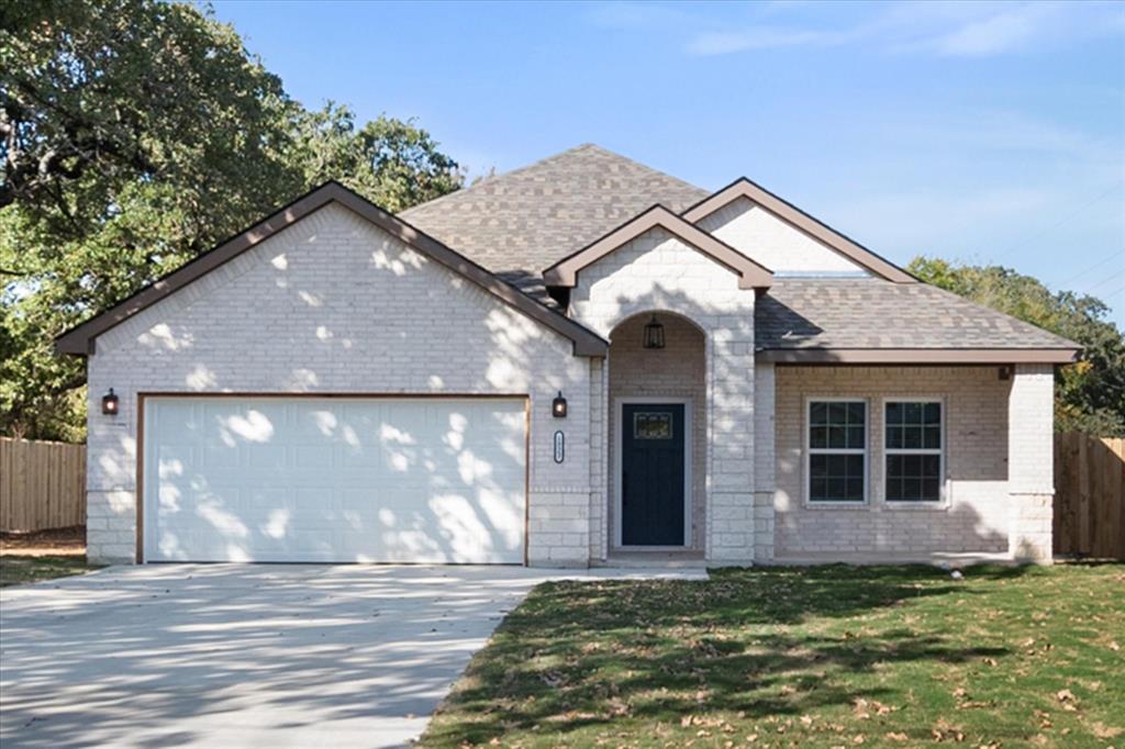 a view of a brick house with a yard