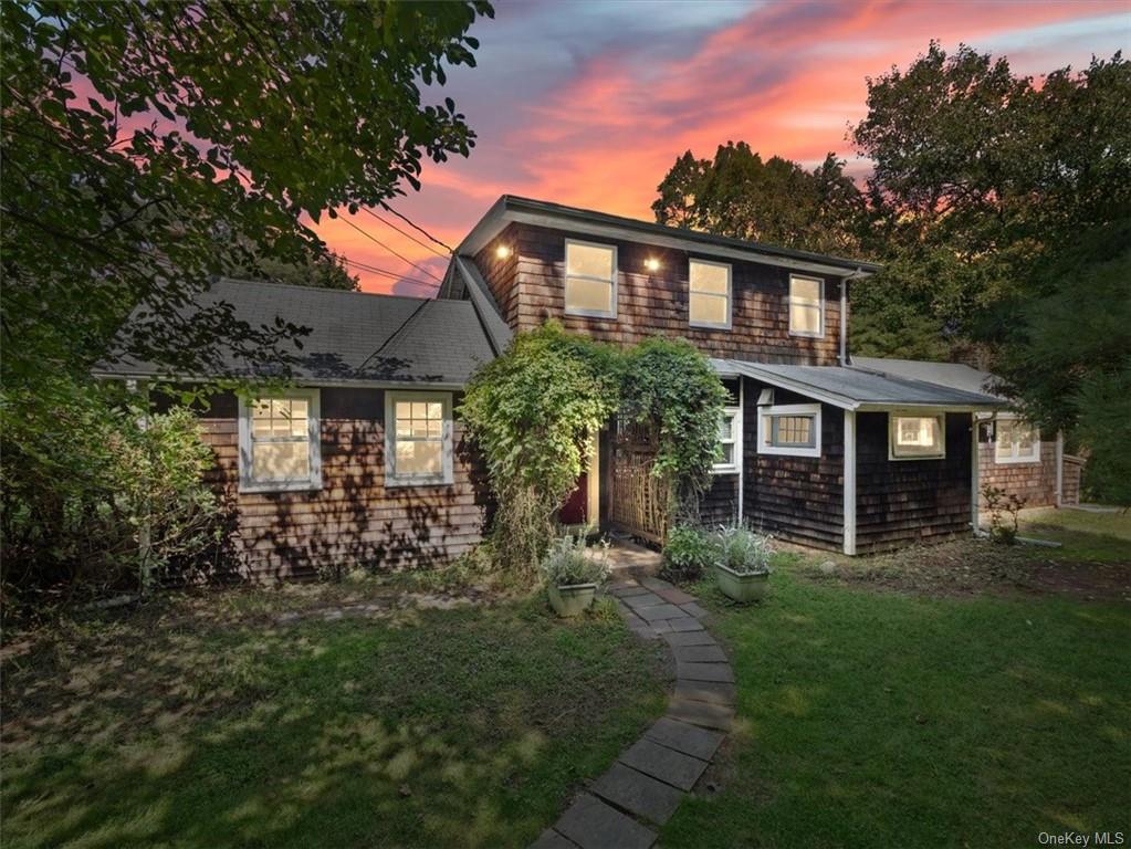 a front view of a house with a garden