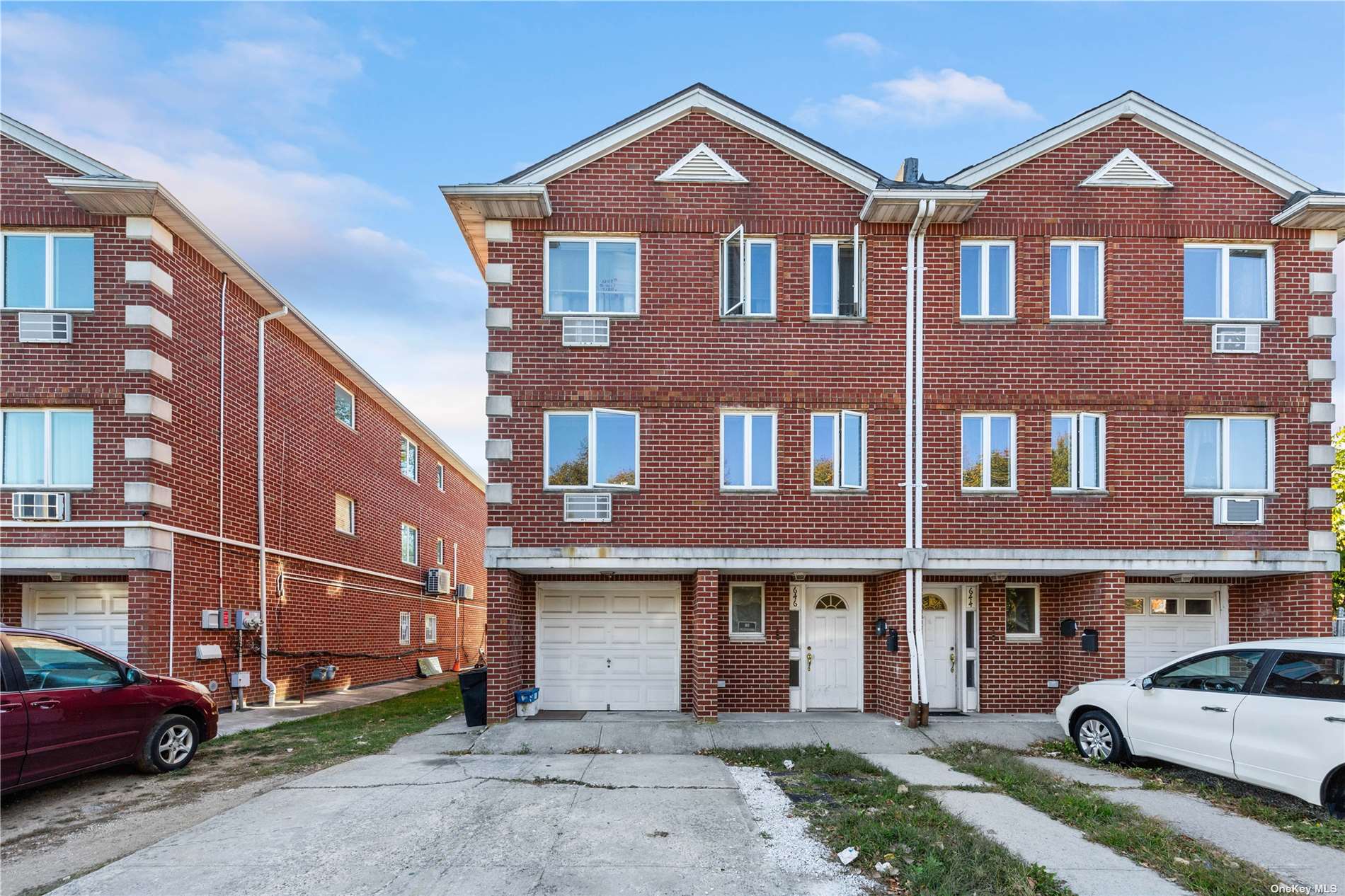 a front view of a residential apartment building with a yard