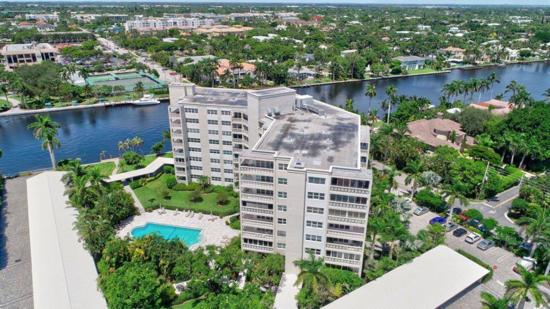 an aerial view of a house with a garden and lake view