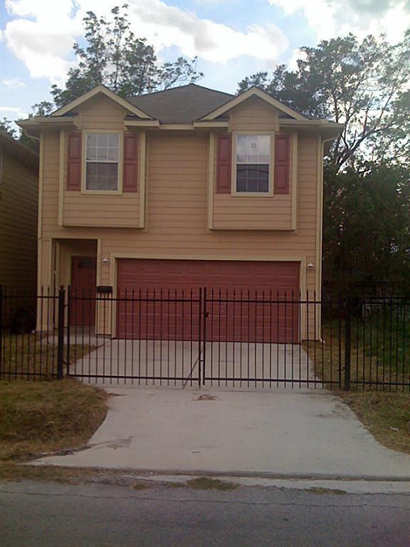 a view of a house with a wooden fence