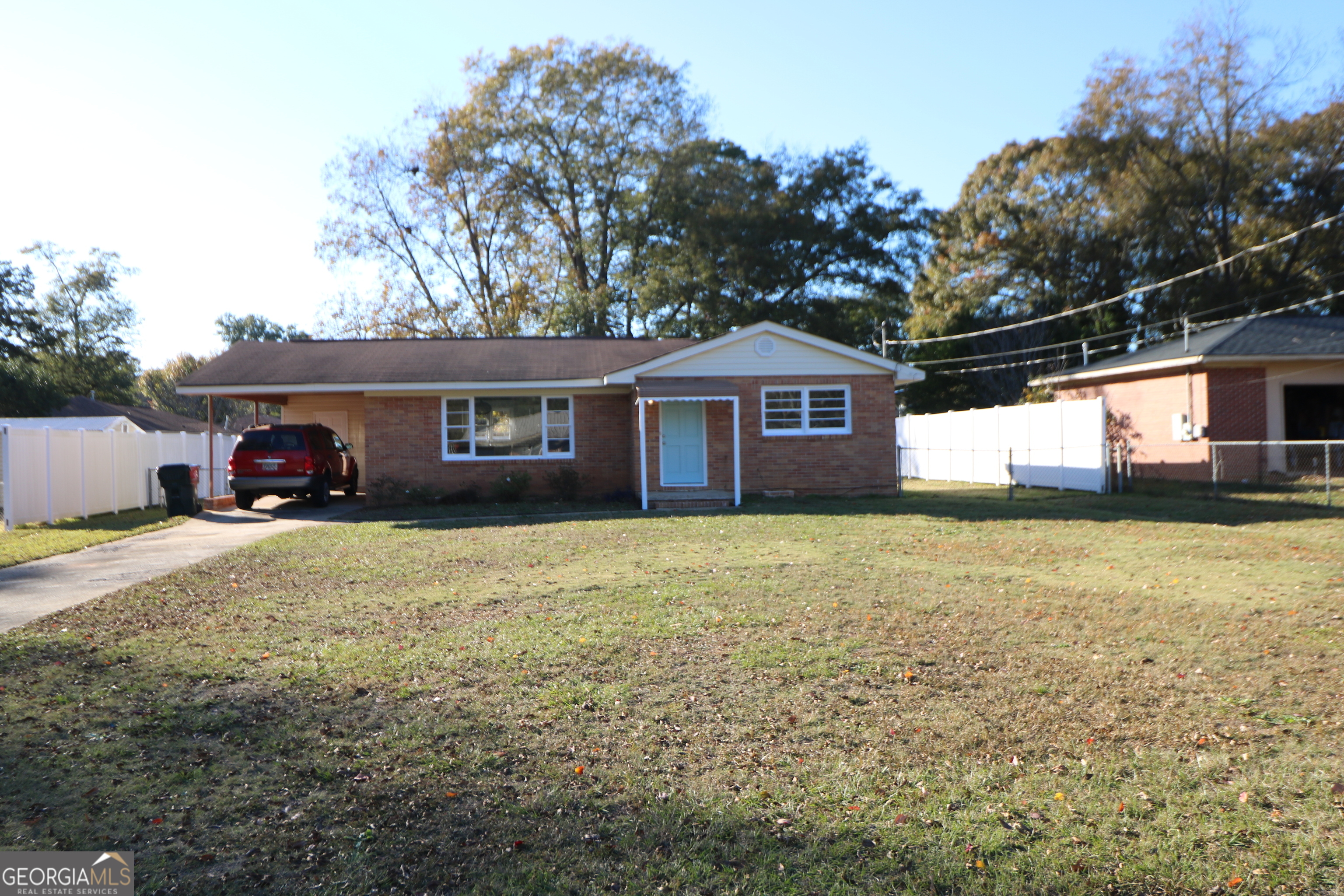 a front view of a house with a garden and yard