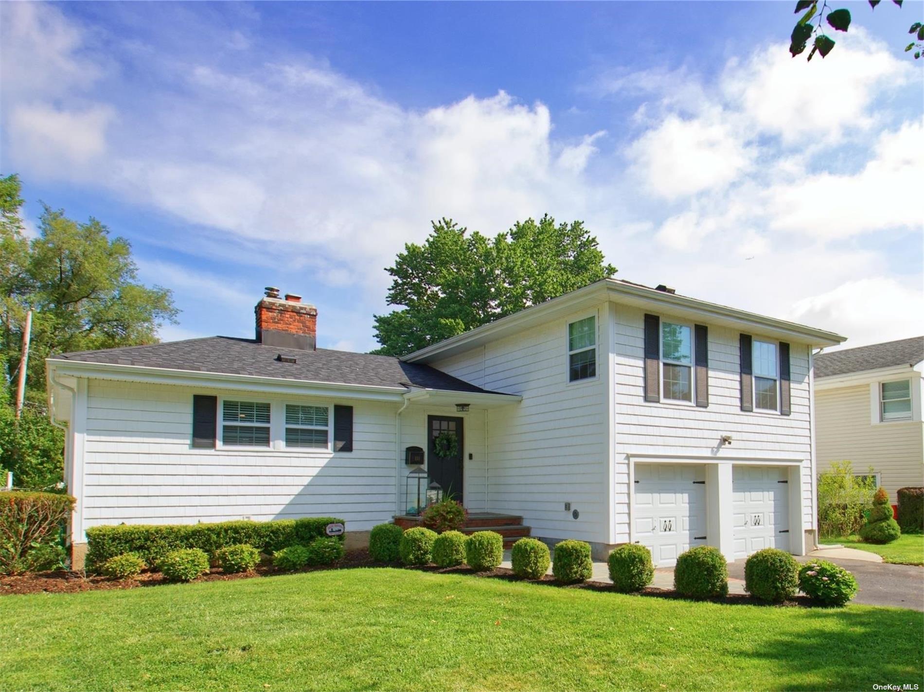 a front view of a house with a garden