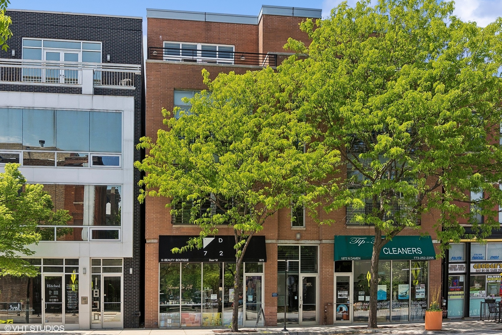 front view of a building with a tree