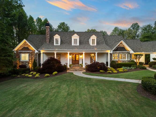 a view of a house with a big yard and potted plants