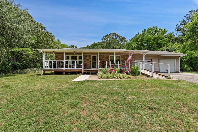 a view of a house with a backyard and a patio