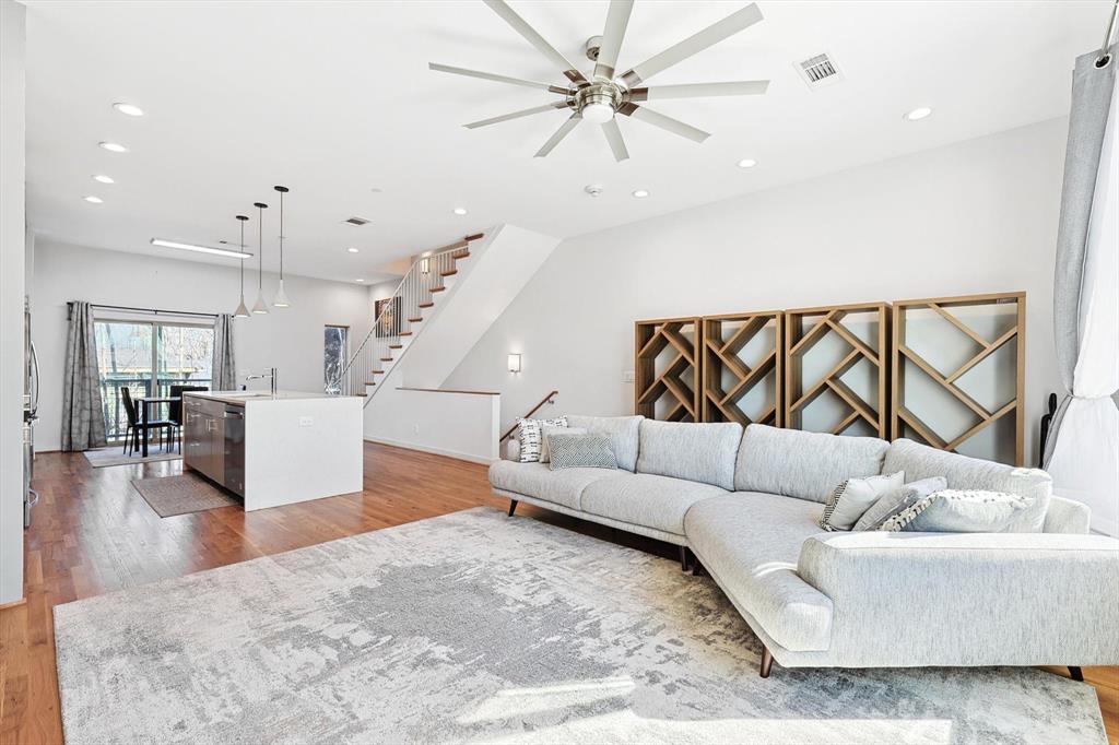 a living room with furniture and wooden floor