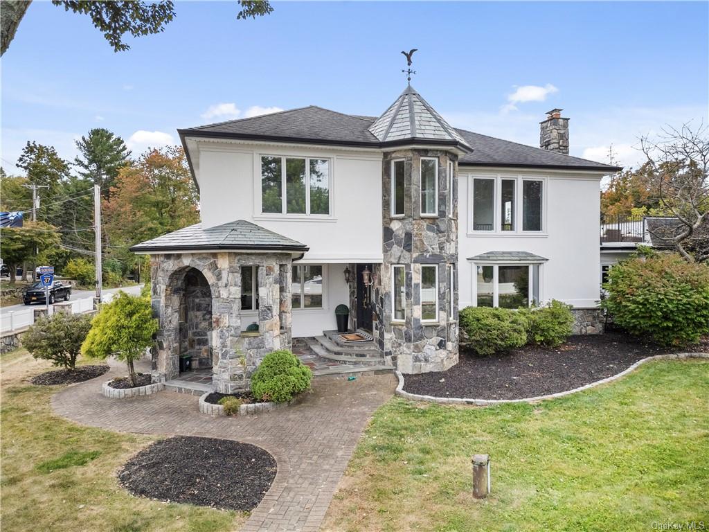 a front view of a house with garden