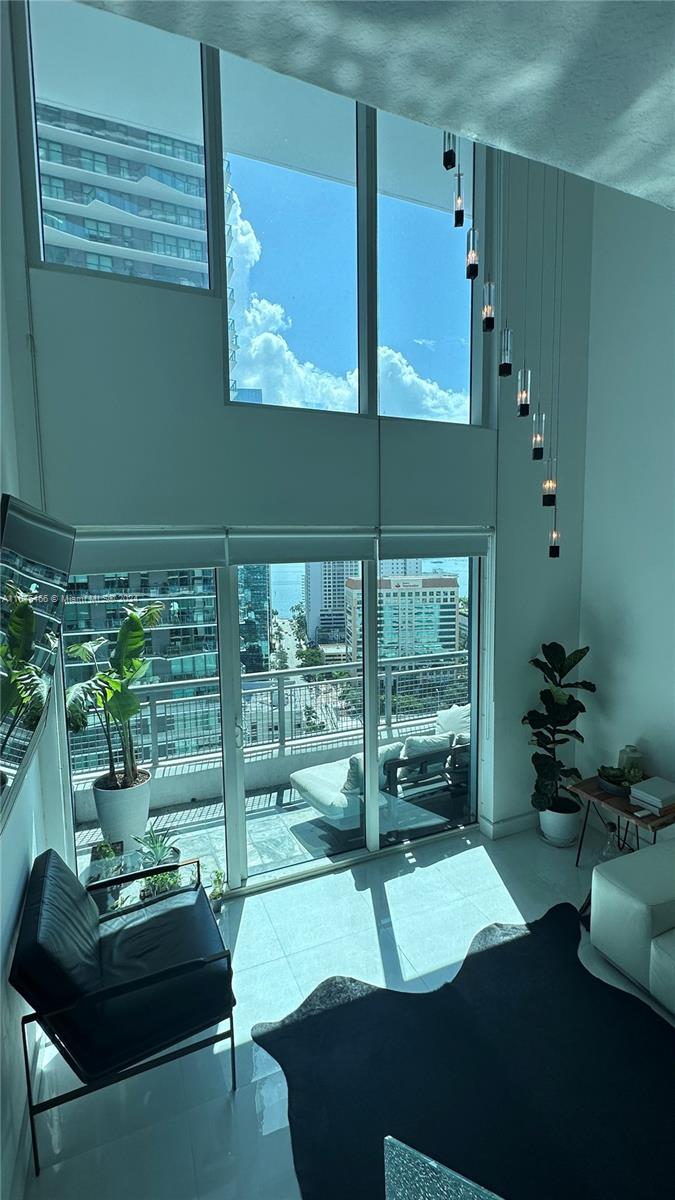 a room with pool table and windows